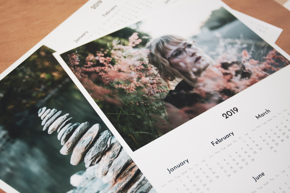 Pile of year to a page photo calendars on a desk