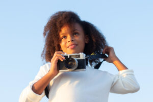 Young girl holding camera