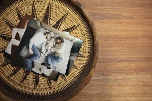 Pile of kodak professional endura lustre photo paper prints in woven tray on table