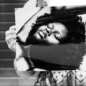 Girl holding a black and white image of a woman printed on kodak professional gloss paper