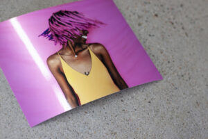 Dark skinned woman with pink hair on pink backdrop printed on kodak professional endura metallic photo paper