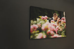 Image of a couple among flowers on a 20mm block mount with black edge hung on a dark wall
