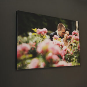 Image of a couple among flowers on a 20mm block mount with black edge hung on a dark wall