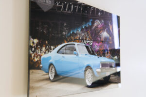 Acrylic flush mount print of a classic car floating off a white wall