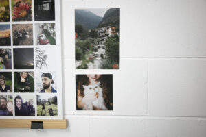 Images printed onto stickers stuck on whiet brick wall next to instagram poster collage hanging in ikea frame
