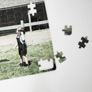 Photo puzzle of young girl with pieces ready to complete puzzle