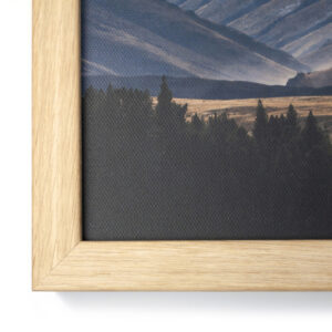 Close up of the corner of an oak framed canvas print with canvas texture