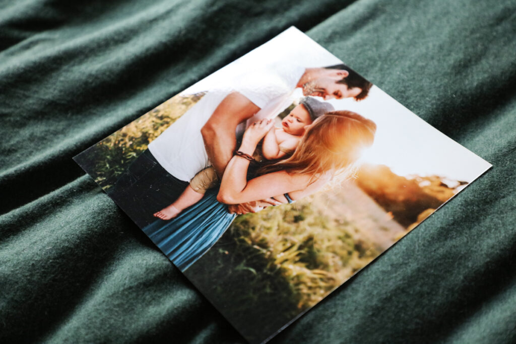 Glossy Photo Print Glossy photographic print on a bed of a mum, dad and child