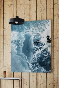 Abstract blue image printed on aluminium hanging on wood panelled wall