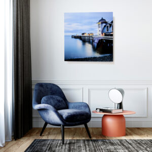 Aluminium print of a jetty over smooth water hanging on a wall in a modern interior