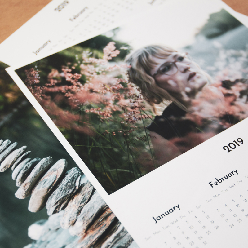 Pile of year to a page photo calendars on a desk