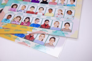 Pile of composite prints with laminate on a white table - school composite building