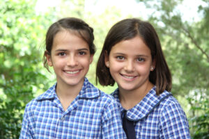 School photo of two sisters wearing school uniform