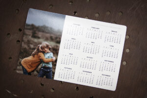 Photo magnet calendar with a whole year and an image of a girl hugging a boy