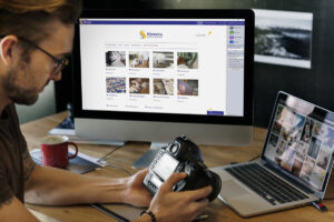 Photographer sitting at a desk using the Streets Online Ordering Software